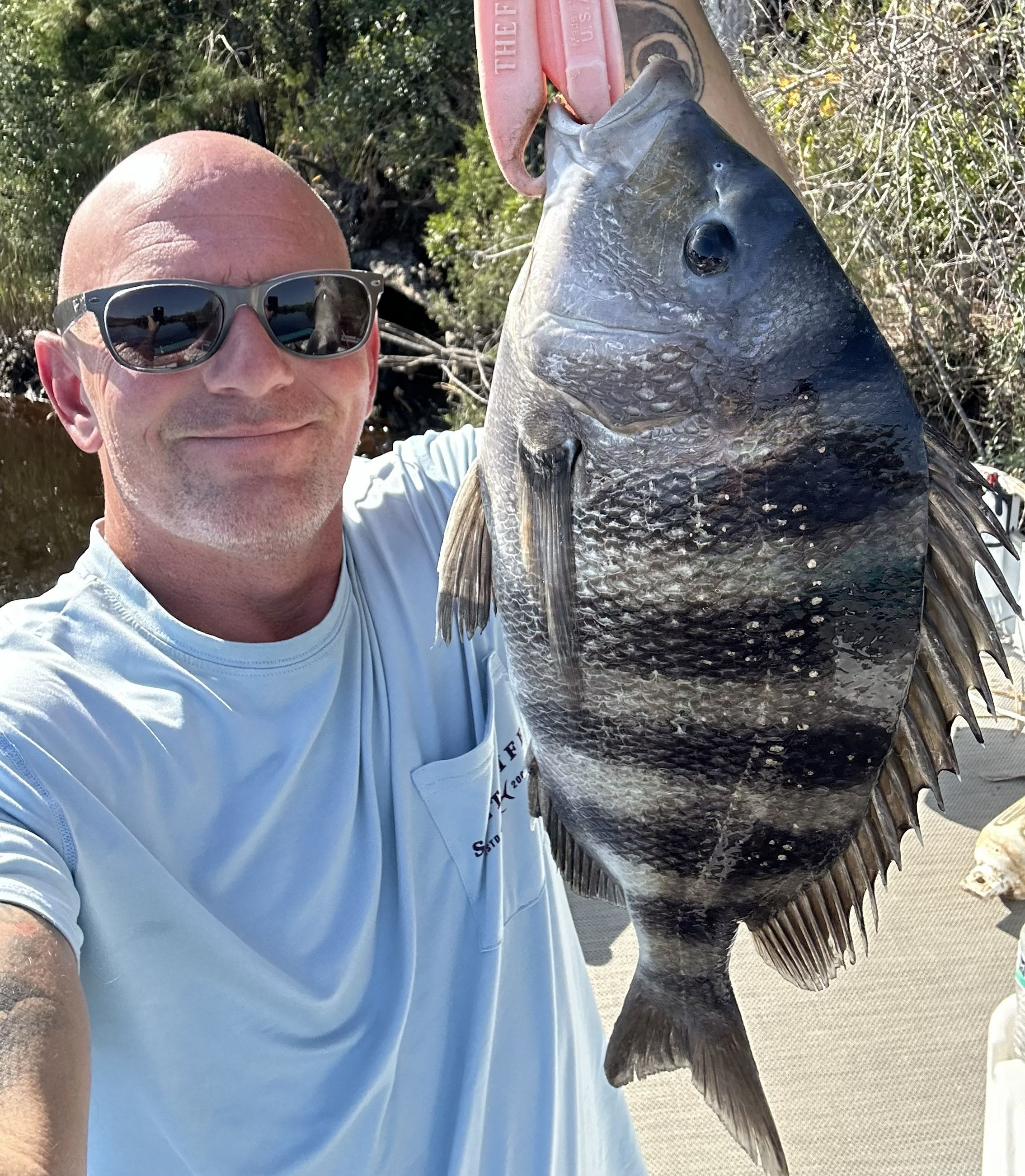 Angler holding a fish during a private Gator Hole charter